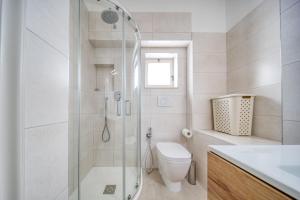 a bathroom with a shower and a toilet and a sink at Franza 2 in Torre San Giovanni Ugento +18 photos