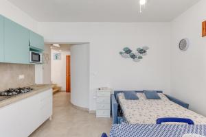 a small kitchen with a bed in a room at Franza 2 in Torre San Giovanni Ugento