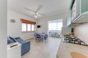 a kitchen and living room with a couch and a table at Franza 2 in Torre San Giovanni Ugento