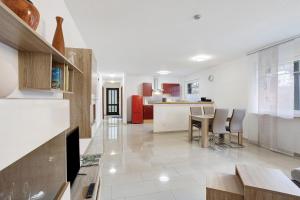 a kitchen and living room with a table and chairs at Ferienwohnung Gaberle in Balve