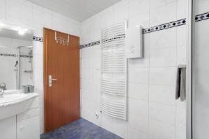 a bathroom with a shower and a sink and a mirror at Ferienwohnung Gaberle in Balve +21 photos