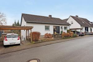 a white car parked in front of a house at Ferienwohnung Gaberle in Balve