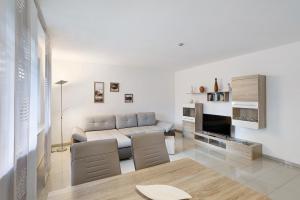 a living room with a couch and a table at Ferienwohnung Gaberle in Balve