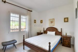 a bedroom with a bed and a window at Villa Romantica by Easy Brava in Calonge
