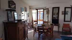 a kitchen with a table and chairs and a dining room at Appartement Roc Sol I Neou in Puyvalador