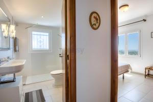 a bathroom with a toilet and a sink at Villa Romantica by Easy Brava in Calonge +22 photos
