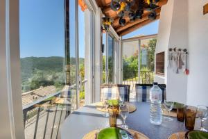 a dining room with a table with a view of a balcony at Villa Romantica by Easy Brava in Calonge