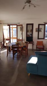 a living room with a table and chairs and a couch at Appartement Roc Sol I Neou in Puyvalador