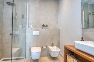 a bathroom with a shower and a toilet and a sink at Casa dins el Mar en Calella in Calella de Palafrugell +18 photos