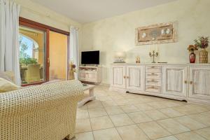 a living room with a couch and a television at Mazzini Apartment - by And Service in Golfo Aranci