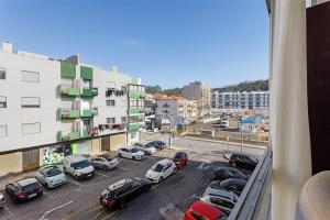 a view from a balcony of a parking lot with cars at Natalina T2 in Nazaré