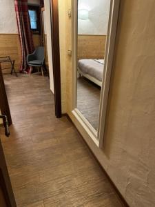 a hallway with a mirror and a bed in a room at Maison Maribel in Pré-Saint-Didier