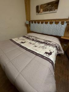 a bed with a quilt on it in a bedroom at Maison Maribel in Pré-Saint-Didier