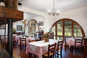 a dining room with tables and chairs with pink tablecloths at La Cerretola in Città della Pieve
