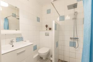 a bathroom with a toilet and a sink and a shower at Chalets De L’arriutort 2 - Laruns in Laruns
