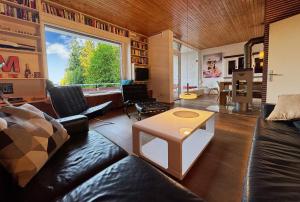 a living room with a couch and a table at Alpenblick-Hotzenwald in Rickenbach