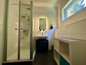 a bathroom with a shower and a sink at Alpenblick-Hotzenwald in Rickenbach +37 photos
