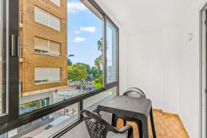 a balcony with a chair and a view of a street at Unique hotel apartment 1-2 in Torrevieja