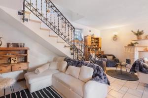 a living room with a couch and a staircase at Chalet Royal in Livigno