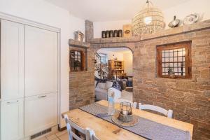 a dining room with a table and a brick wall at Chalet Royal in Livigno
