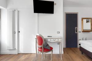 a room with a desk and a red chair at Bnb and Breakfast Pellizzano in Pellizzano +36 photos