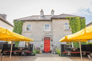 a building with tables and umbrellas in front of it at Gleeson's Roscommon in Roscommon