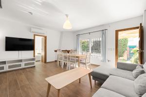 a living room with a couch and a table at La Casa de la Cala del Moral in Cala del Moral