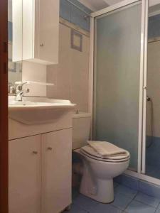 a bathroom with a toilet and a sink and a shower at Emma's studio house by Kapsali beach in Kapsali