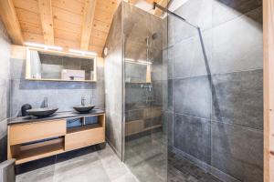a bathroom with two sinks and a shower at Germain Ski Lodge in La Toussuire +25 photos