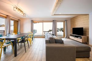 a living room with a couch and a table at Germain Ski Lodge in La Toussuire