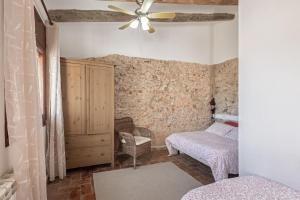 a bedroom with two beds and a ceiling fan at Cal Cabrer in Sant Jaume dels Domenys +30 photos