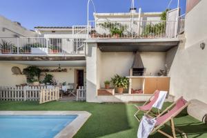 a house with a swimming pool and a patio at Cal Cabrer in Sant Jaume dels Domenys