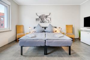 a bedroom with a bed with a cow on the wall at Stadtquartier Ahaus in Ahaus
