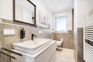 a bathroom with a sink and a toilet at Stadtquartier Ahaus in Ahaus +17 photos