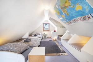 a attic bedroom with beds and a map on the ceiling at Ferienwohnung Lemburg in Nindorf