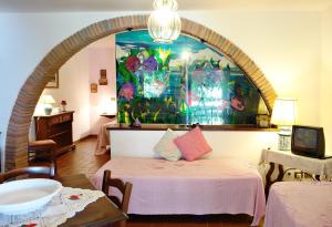 a room with a bed and a painting on the wall at La Cerretola in Città della Pieve