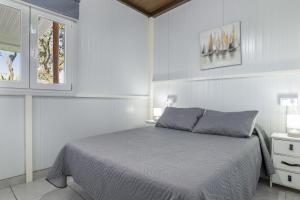 a white bedroom with a bed and a window at El encanto de Ronda in Ronda +26 photos