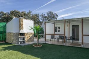 a house with a fireplace and a patio at El encanto de Ronda in Ronda