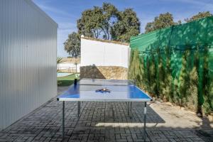 a ping pong table in front of a wall at El encanto de Ronda in Ronda