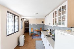 a kitchen with white cabinets and a sink at Old street 2 in Podgorica