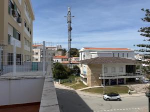 a small white car parked in front of a building at Humen apartamento T2 in Tavira