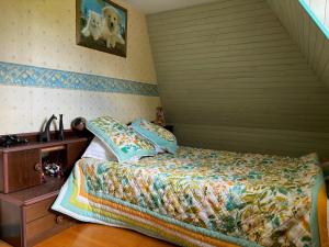 a bedroom with a bed and a sink in it at Gite rural La Madeleine in Saint-Mathurin-Léobazel