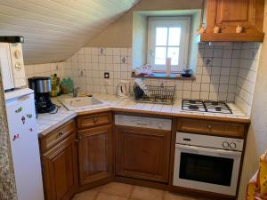 a kitchen with a sink and a stove top oven at Gite rural La Madeleine in Saint-Mathurin-Léobazel +20 photos