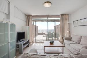 a living room with a couch and a table at Casa Médano 18 in Granadilla de Abona