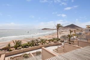 a view of the beach from the balcony of a resort at Casa Médano 18 in Granadilla de Abona