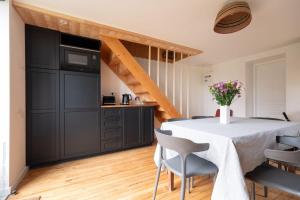 a kitchen and dining room with a table and chairs at Charming Gîte Le 1681 Xl in Girancourt