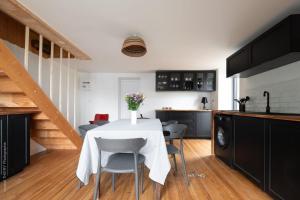 a kitchen and dining room with a table and chairs at Charming Gîte Le 1681 Xl in Girancourt