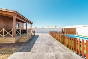a villa with a pool and a house at Casa Hefestión in Conil de la Frontera