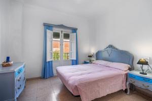 a bedroom with a blue bed and a window at Casa Adriana con piscina in Murchas +23 photos