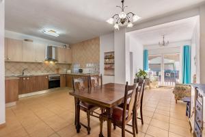 a kitchen and dining room with a table and chairs at Casa Adriana con piscina in Murchas